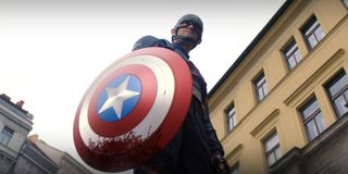 Wyatt Rogers as John Walker Captain America holding bloody shield in The Falcon And The Winter Soldier