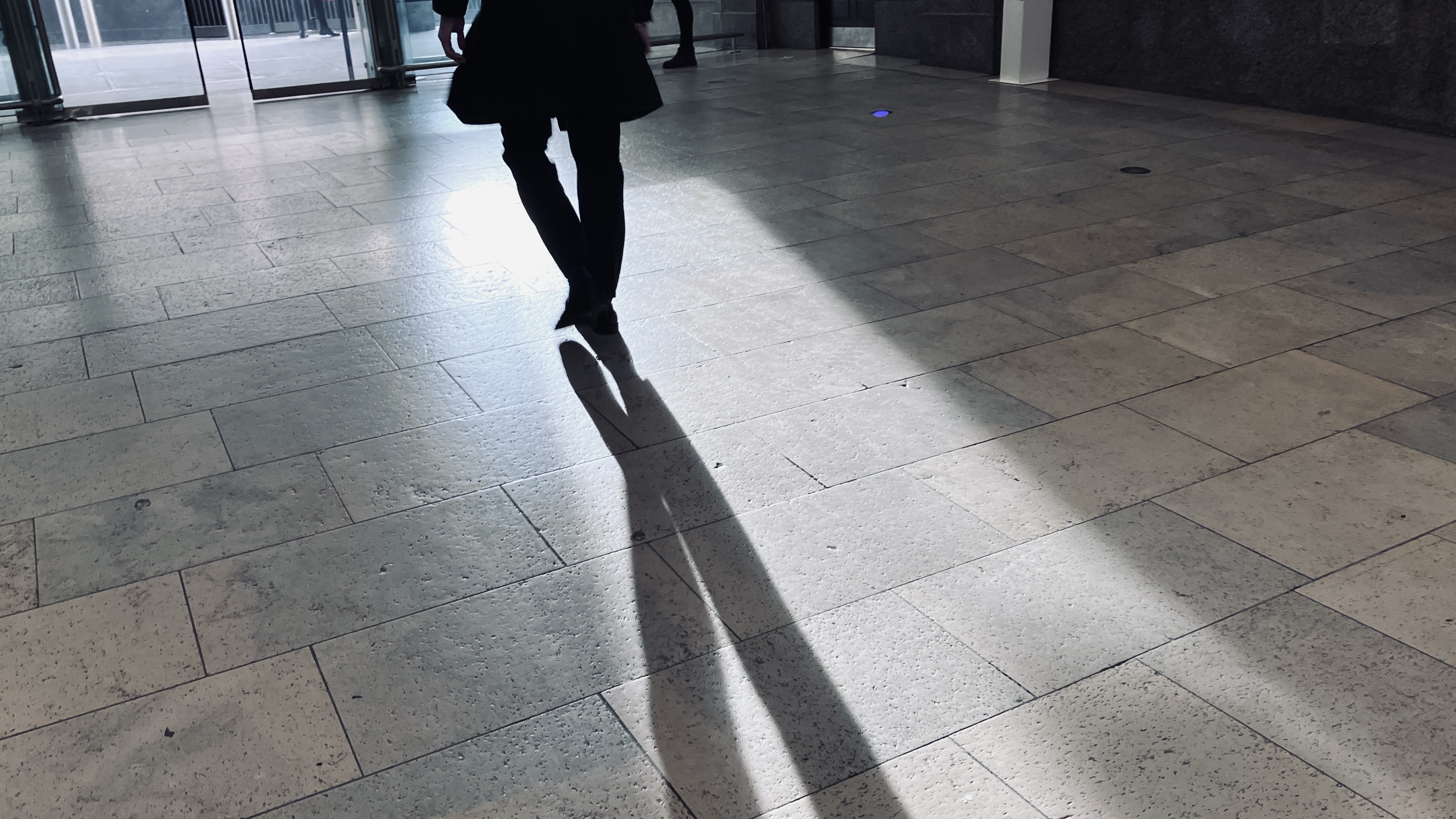 Man walking in shadow and light