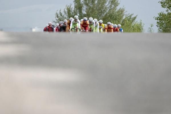 The peloton pops up over a rise.