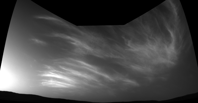 NASA's Curiosity Mars rover imaged these drifting clouds on May 17, 2019, the 2,410th Martian day, or sol, of the mission, using its black-and-white Navigation Cameras.