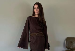 @annabelrosendahl wearing a brown NA-KD boatneck long-sleeve maxi dress with a belt.