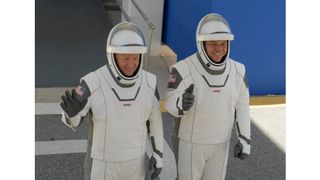 NASA astronauts Bob Behnken and Doug Hurley walk out of NASA's Astronaut Crew Quarters and take a Tesla Model X to Launch Pad 39A during a dry-run test of their SpaceX Crew Dragon Demo-2 flight on May 23, 2020 at the Kennedy Space Center in Florida.