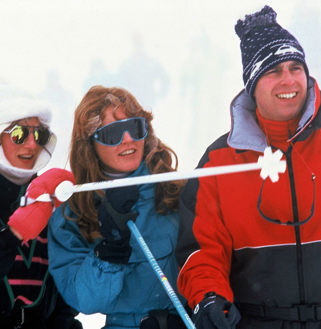 Princess Diana, Sarah Ferguson and Prince Andrew laughing and wearing ski suits