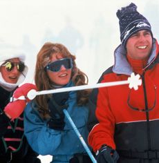 Princess Diana, Sarah Ferguson and Prince Andrew laughing and wearing ski suits