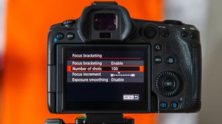 The back of a Canon EOS R5 showing the focus bracketing menu and the number of shots set to 100