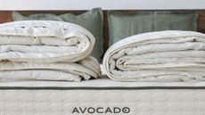 Two folded duvet inserts on an Avocado mattress