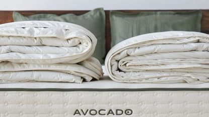 Two folded duvet inserts on an Avocado mattress