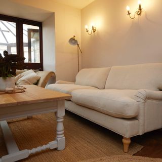 living room with wood coffee table and cream sofa