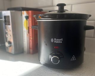 A Russell Hobbs chalkboard slow cooker in kitchen with two cookbooks