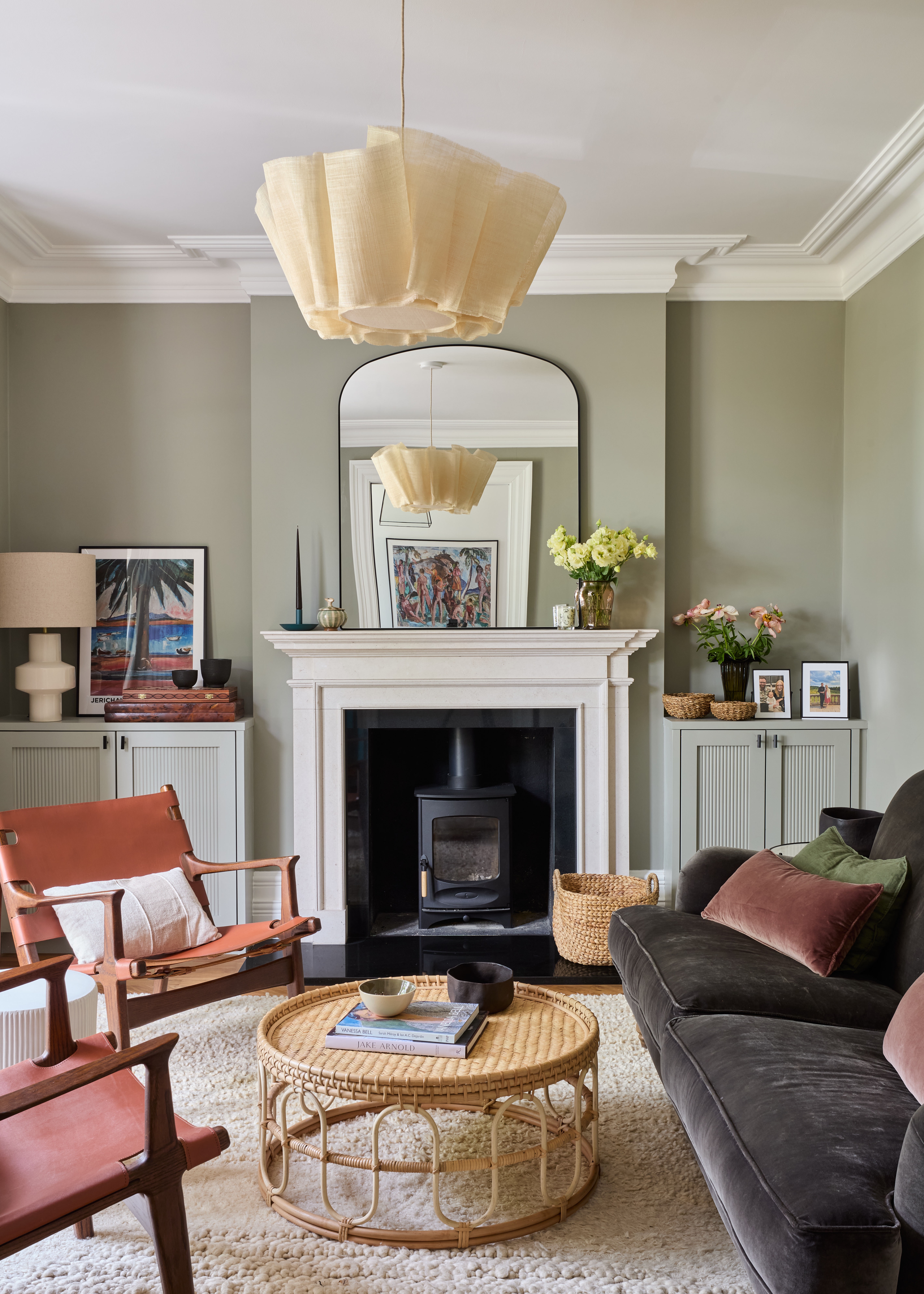 Green living room with grey velvet sofa and pleated fabric ceiling pendant by Imperfect Interiors