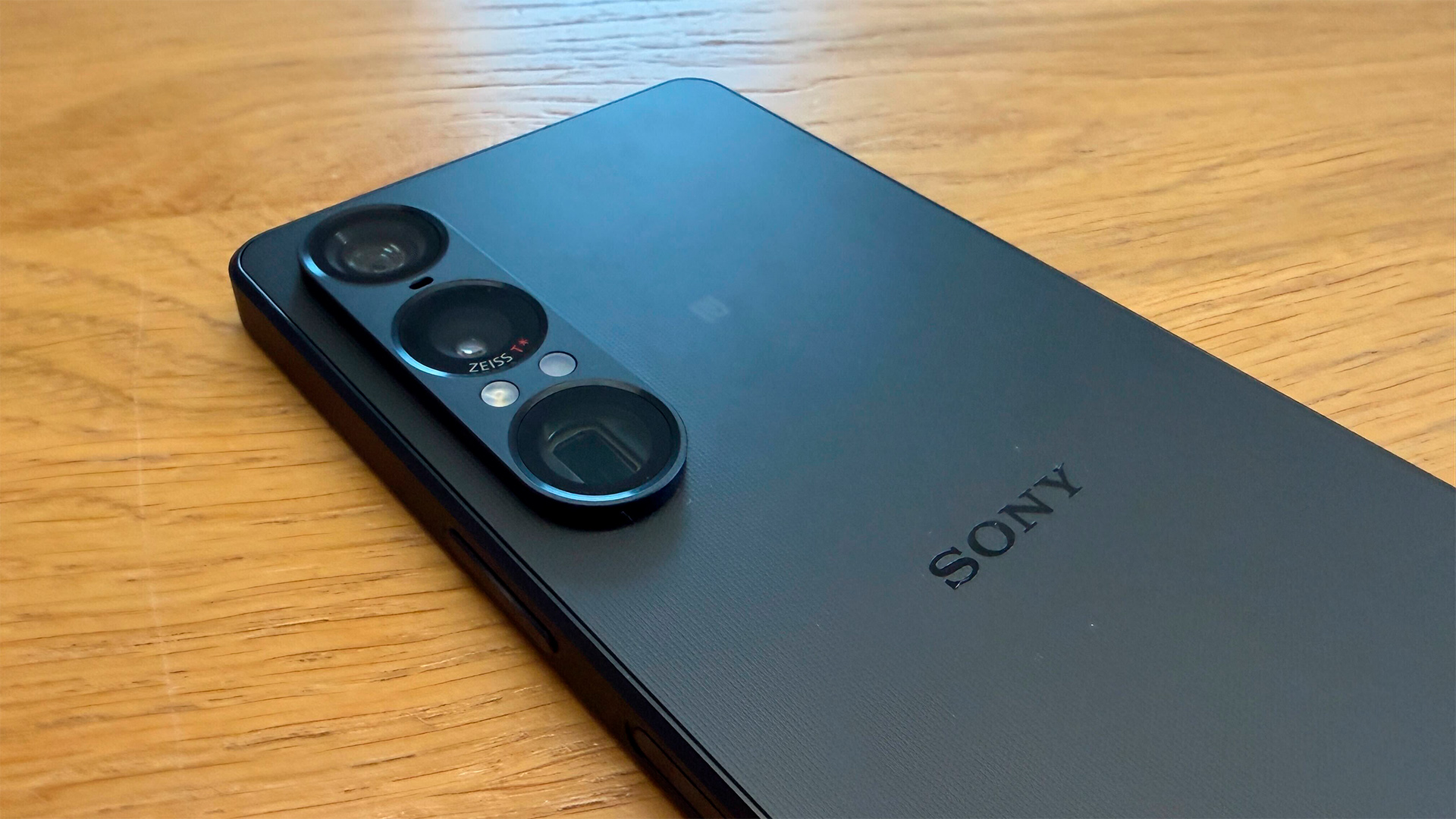 Sony Xperia 1 VII smartphone on wooden table showing rear of phone and camera array