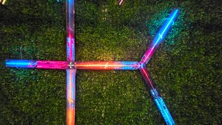 The Govee x Evangelion lighting kits set up on a wall and around a desk and drum kit with various RGB lighting modes enabled.