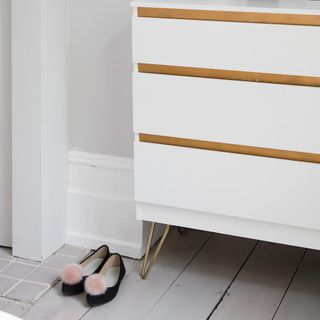 room with white wall and white drawers