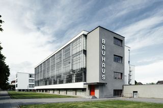 The Bauhaus school building. A four storey rectangular building with BAUHAUS written downwards on the building's front.