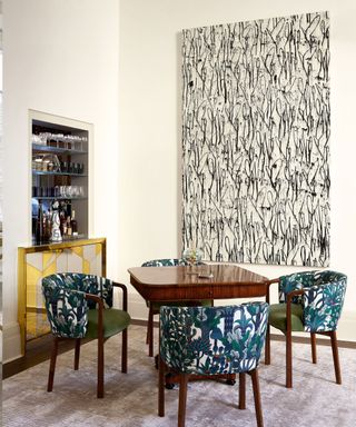 White dining room with bold artwork and dining chairs