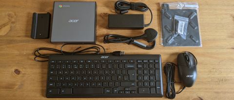 An Acer Chromebox CXI4 mini PC sitting on a wooden desk