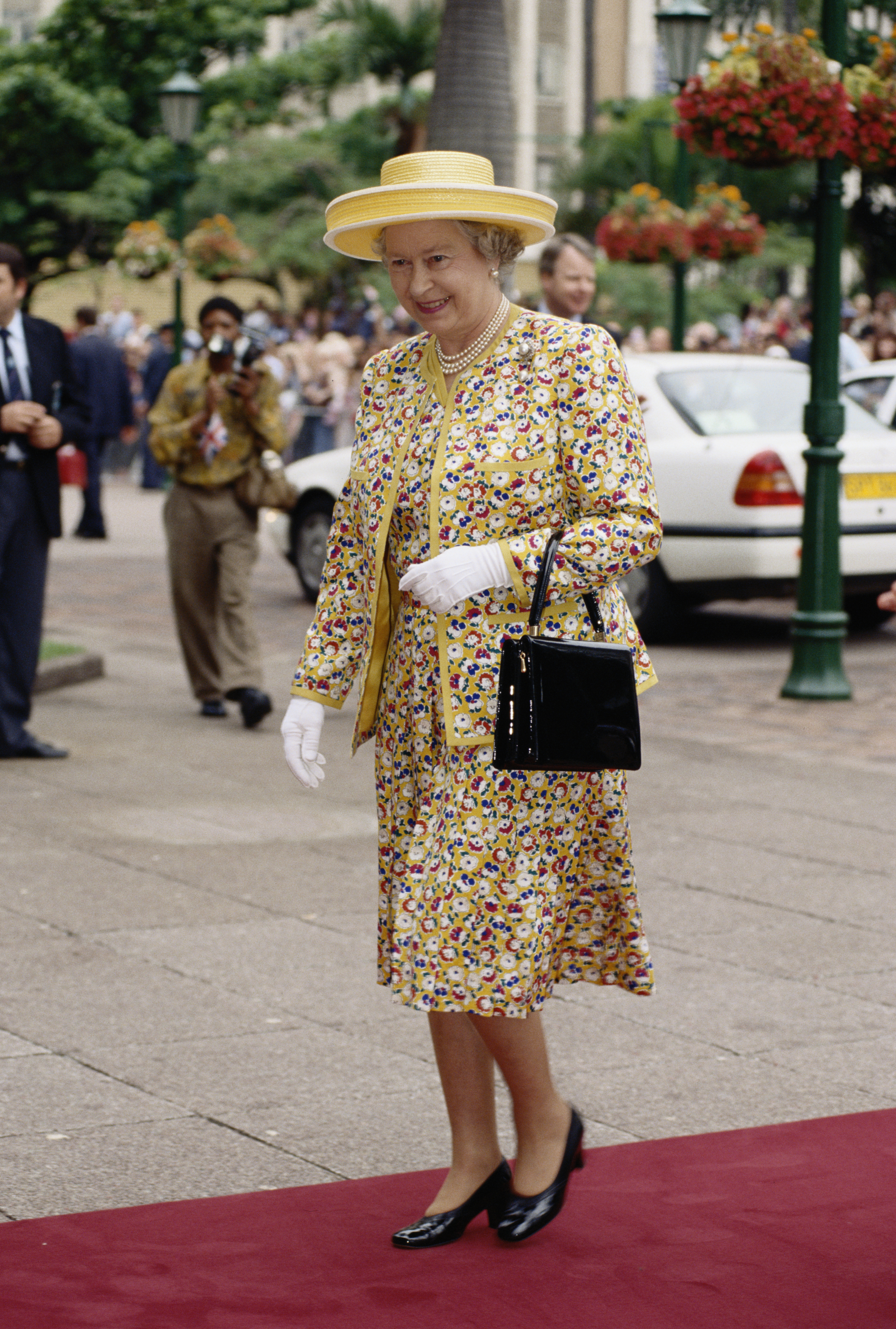 Queen Elizabeth II, wearing a suit by Sir Hardy Amies and carrying a handbag by Launer, in Durban, during a state visit to South Africa, 25 March 1995. (Photo by Tim Graham Photo Library via Getty Images)