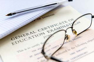 A GCSE certificate and a pair of reading glasses