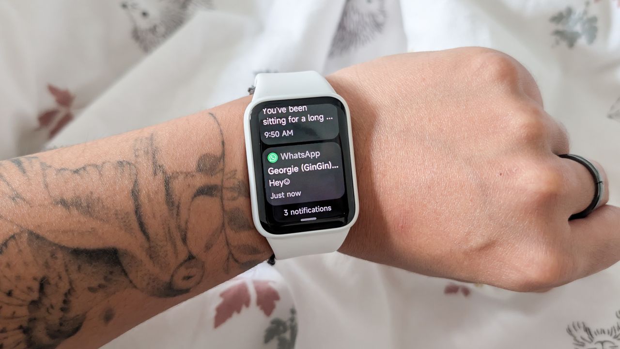 A person wearing a Xiaomi Smart Band 10 Pro smartwatch