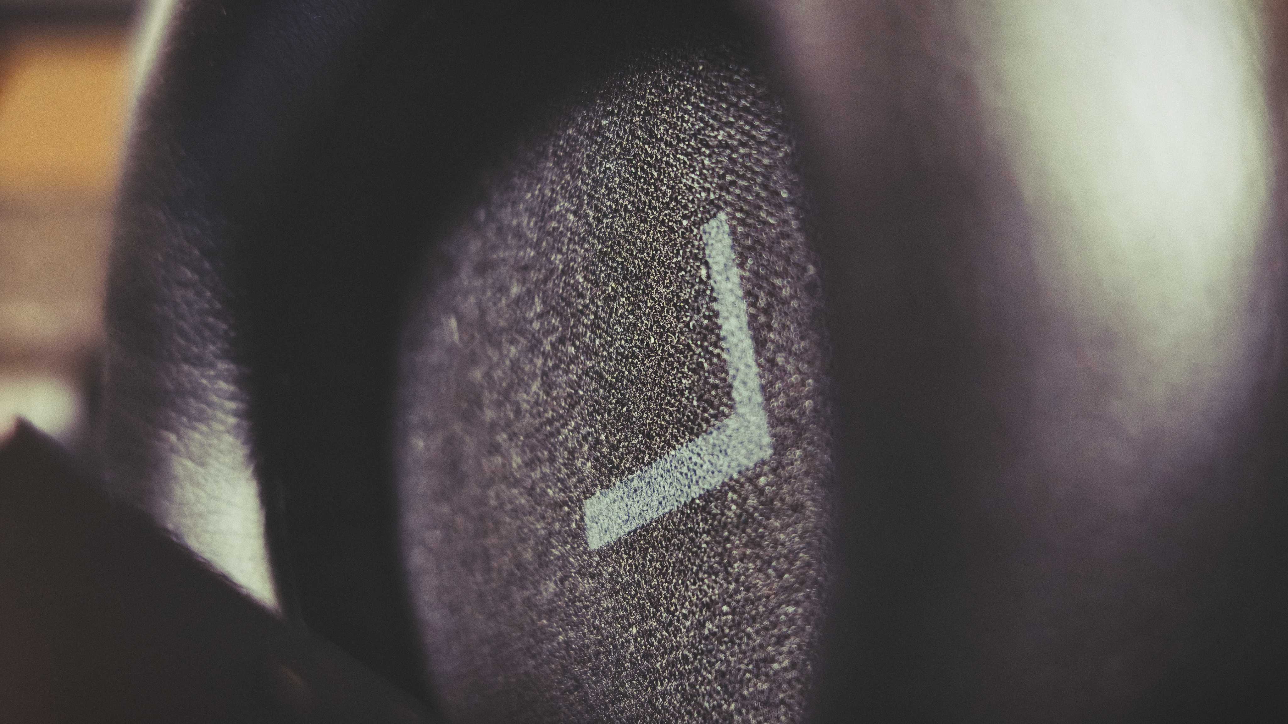 A pair of black OneOdio Focus A6 headphones on a gaming desk mat