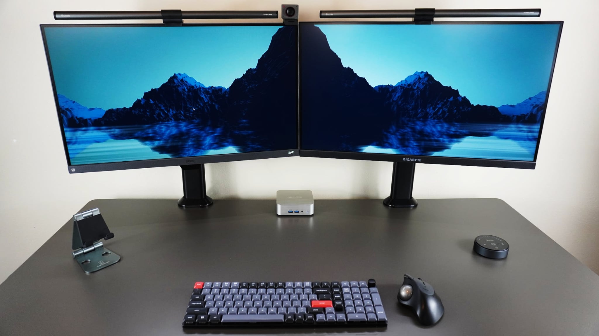 A dual-monitor desk setup built around the Geekom A6