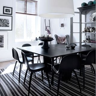dinning room with black and white striped rug and black dinning table