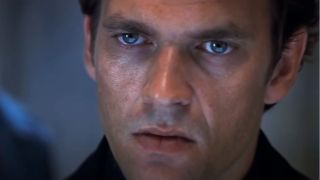 Dougray Scott stands looking annoyed in Mission Impossible II.