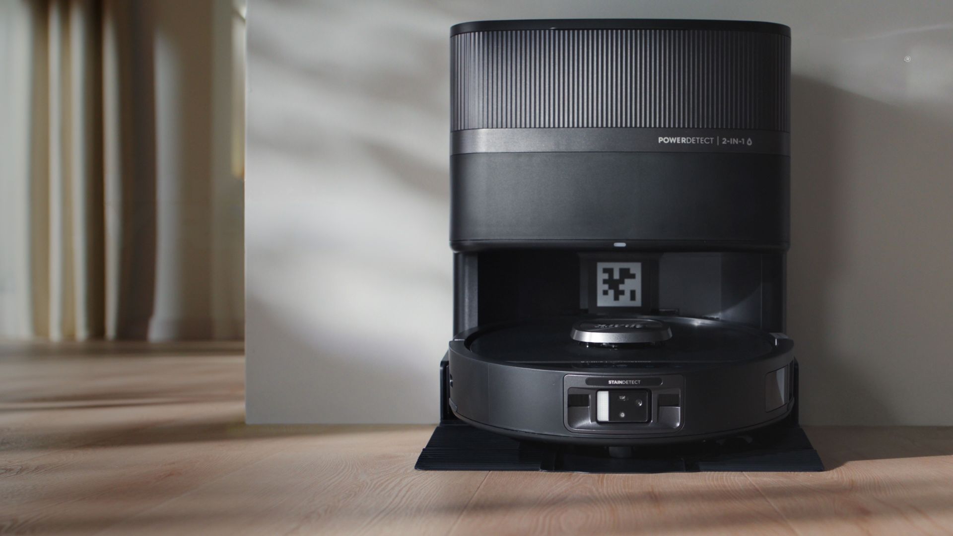 The Shark PowerDetect UV Reveal 2-in-1 Robot Vacuum &amp;amp; Mop on its station in a home