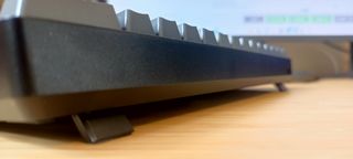 A grey Sablute SG KM61 keyboard sitting on a wooden desk