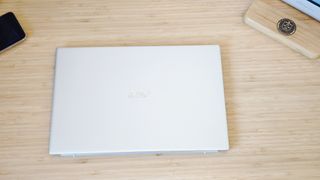 A silver Acer Swift 3 laptop on a light wooden desk