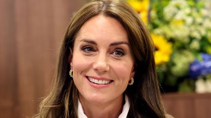 Kate Middleton's "symbol of power" explained. Seen here she hears about experiences of moving to the UK