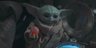 baby yoda holding egg