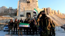 Syrian rebels pose at Aleppo's Citadel after retaking the city on Nov. 30, 2024.