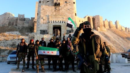 Syrian rebels pose at Aleppo's Citadel after retaking the city on Nov. 30, 2024.