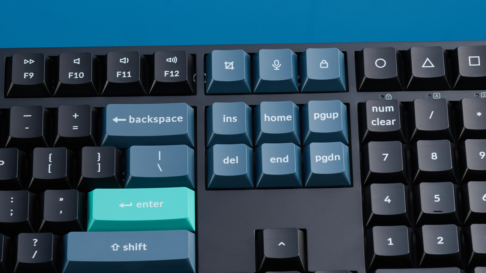 Keychron B36 keyboard and Keychron BM25 mouse photographed in front of a blue background.