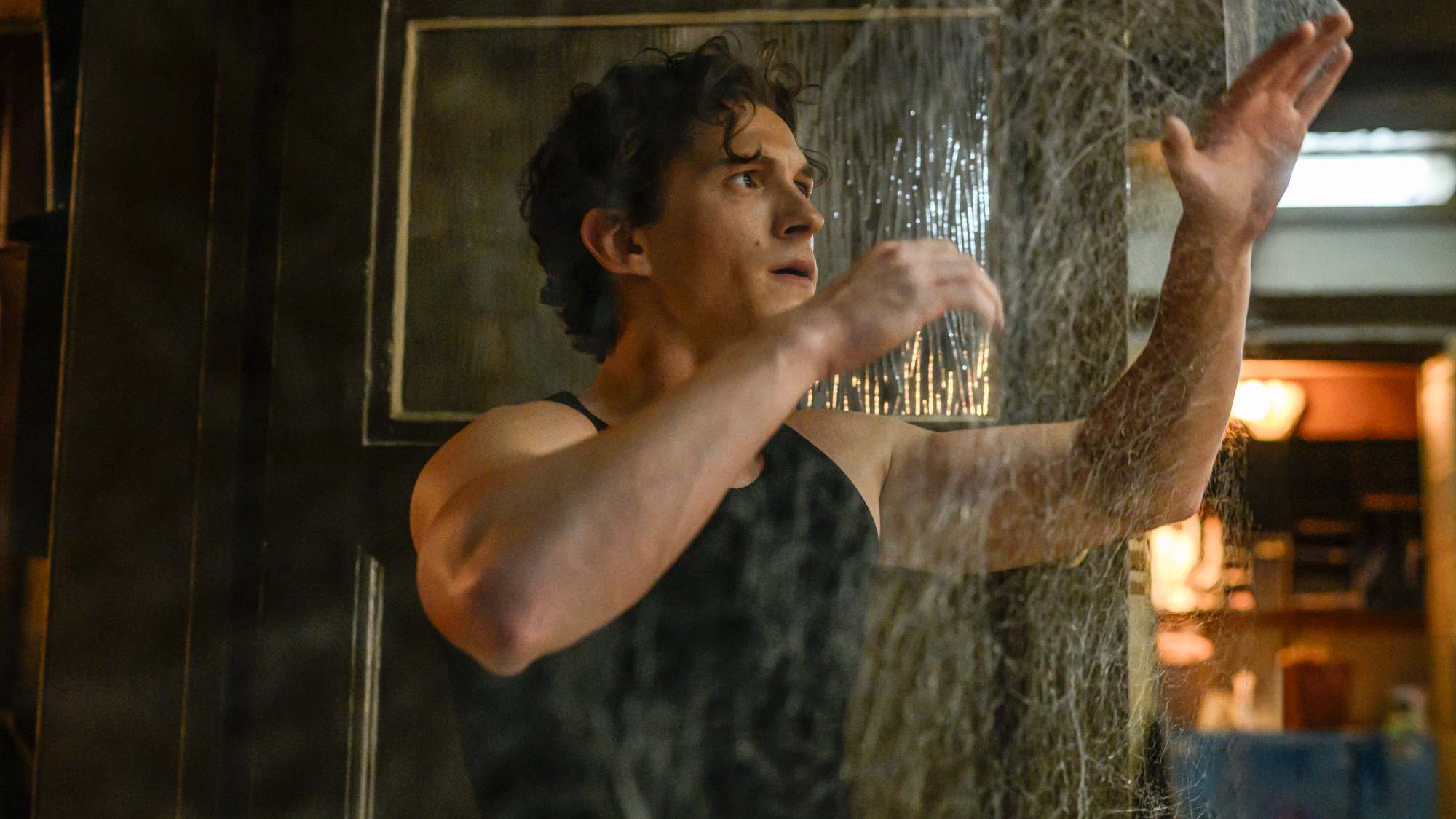 Peter Parker (Tom Holland) looks at webs in Spider-Man: Brand New Day.