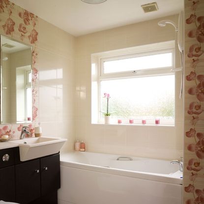 bathroom with cream wall and bathtub