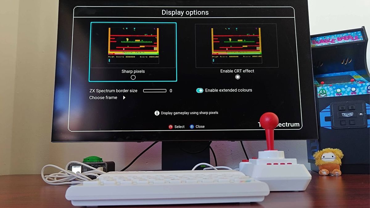 The Spectrum connected to LG OLED monitor with visual settings menu open and "sharp pixels" selected on screen.