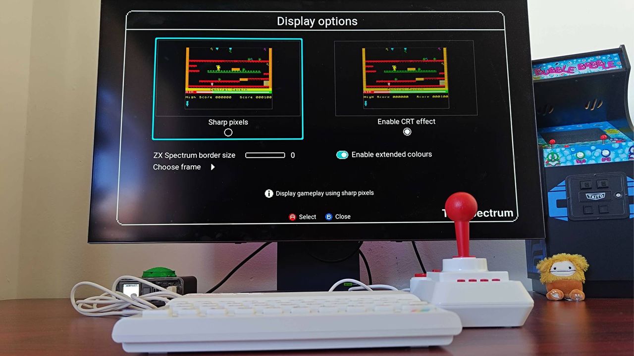 The Spectrum connected to LG OLED monitor with visual settings menu open and "sharp pixels" selected on screen.