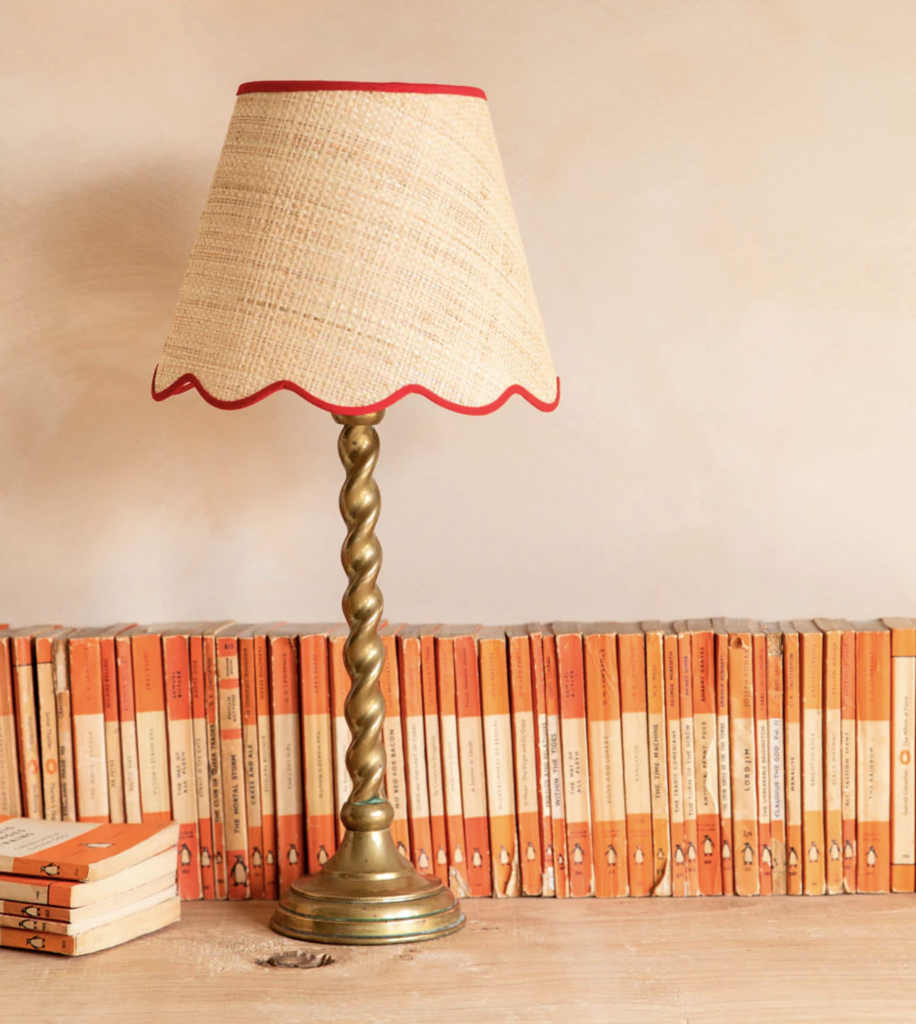 a gold twisted lamp base with a rattan scalloped lampshade