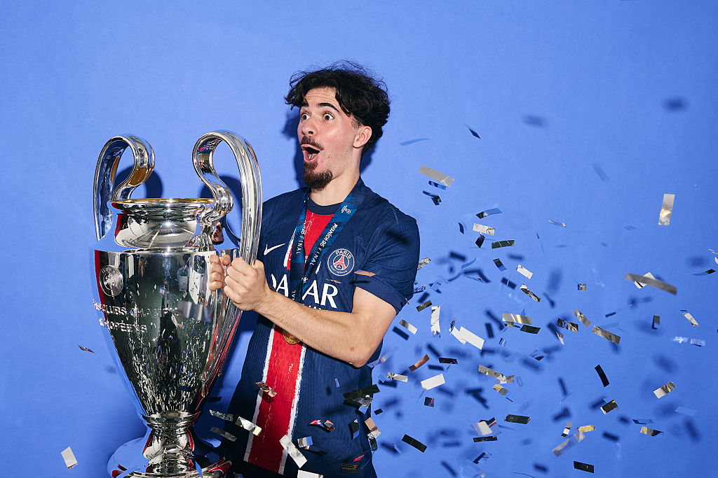 Vitinha of Paris Saint-Germain poses for a photo with the UEFA Champions League Trophy during the official UEFA Champions League Final 2025 Winners' shoot after the UEFA Champions League Final 2025 between Paris Saint-Germain and FC Internazionale Milano on May 31, 2025 in Munich, Germany.