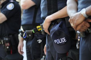 Police officers stand in a line.