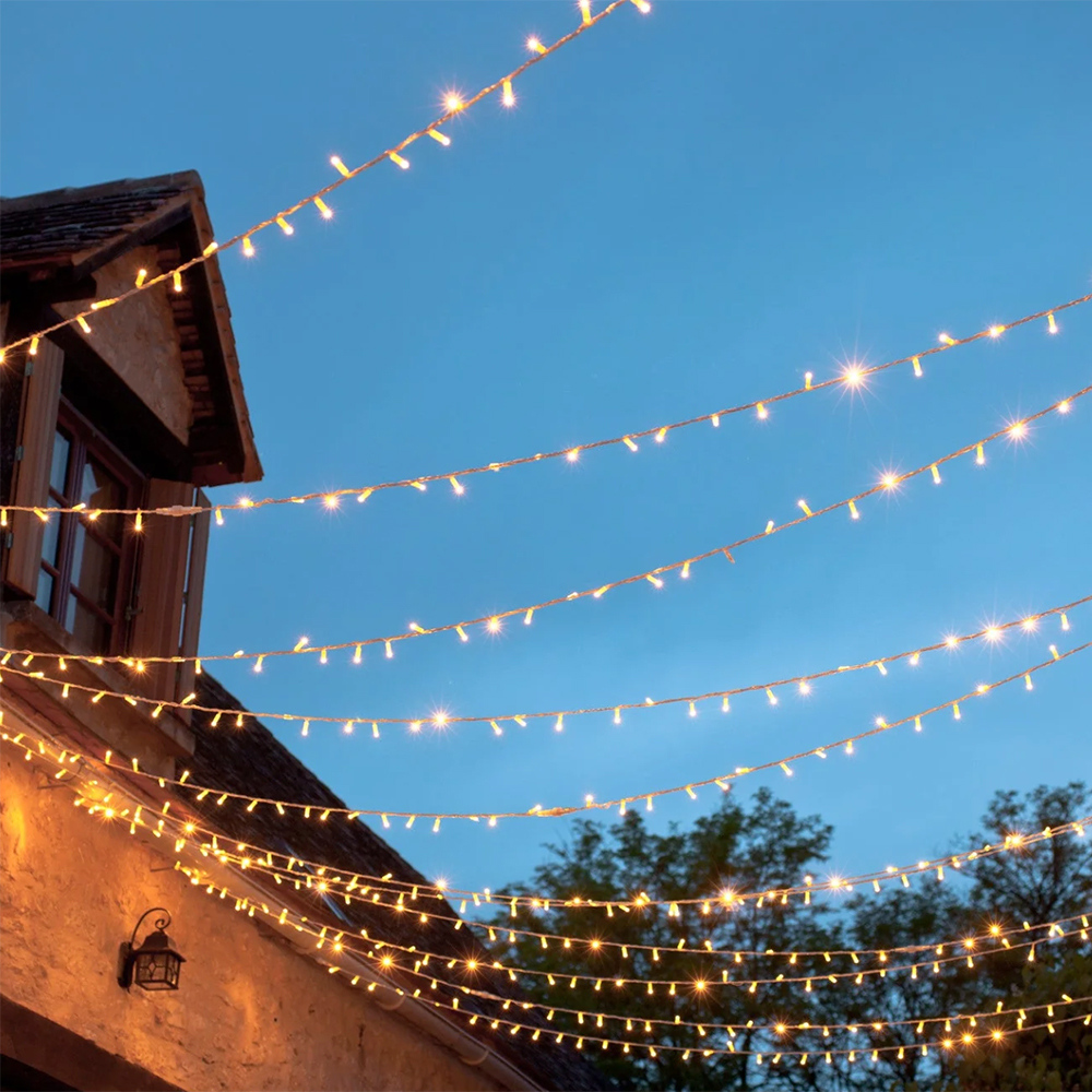 10m string of warm white fairy lights in a garden to create a canopy