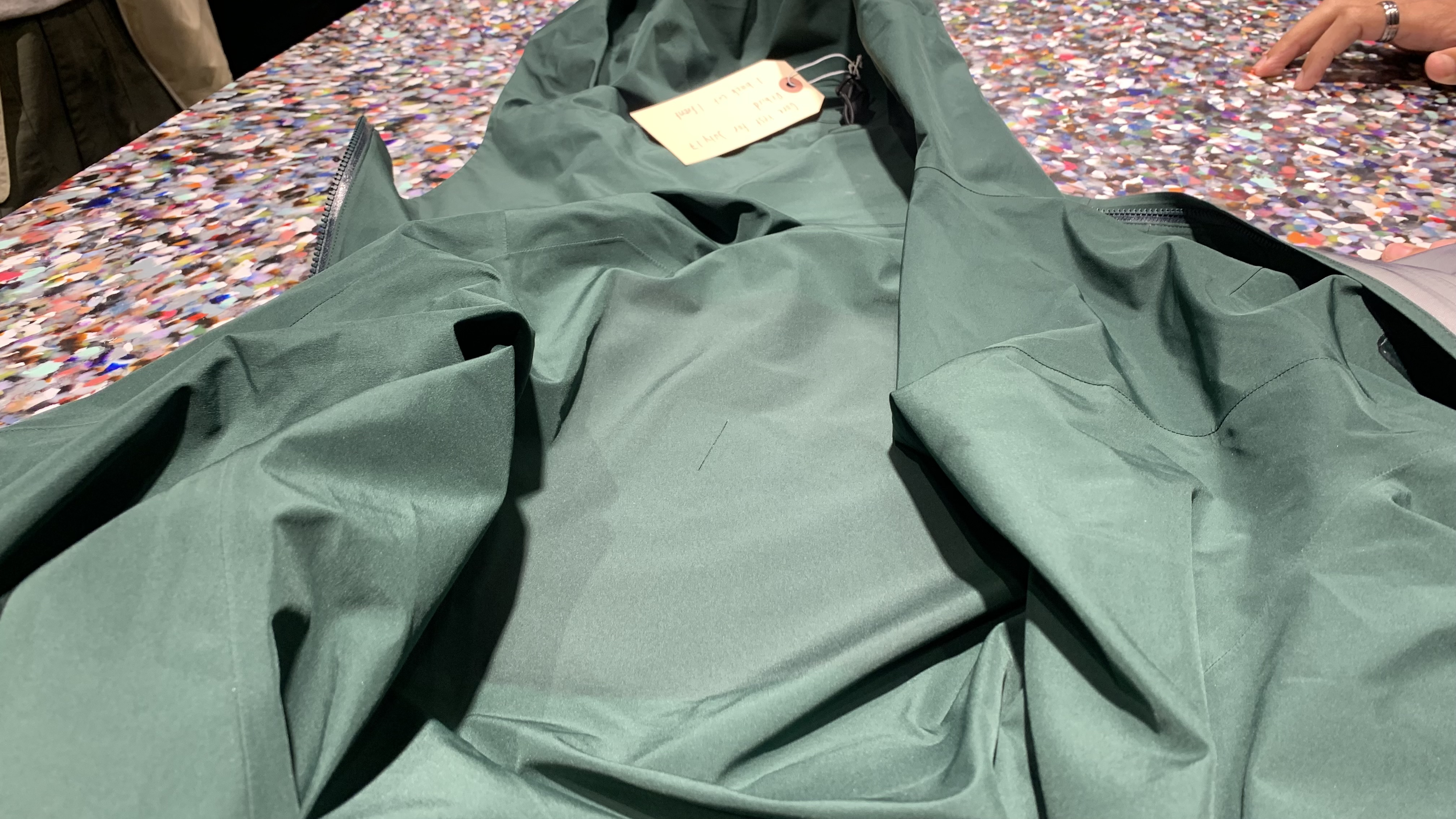 A green Arc'teryx waterproof jacket after being patched