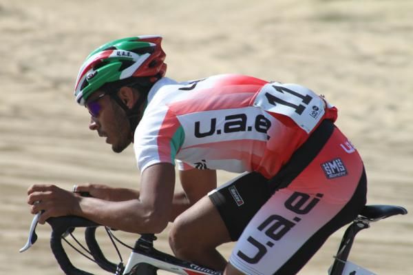 A UAE rider gets his head down as he attacks