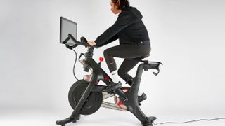Peloton bike being ridden by Sam Hopes, resident fitness writer at Live Science