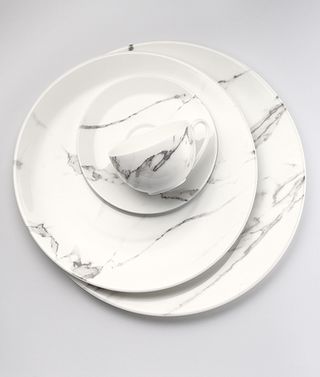'Carrara' marble plates, by Bodo Sperlein, for Dibbern. Three different sized plates of top of each other and a tea cup.