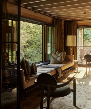 The corner of a chalet dining table filled with a 13-foot antique daybed