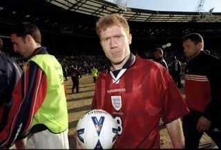 Paul Scholes clutches the match ball after scoring a hat-trick for England against Poland in March 1999.