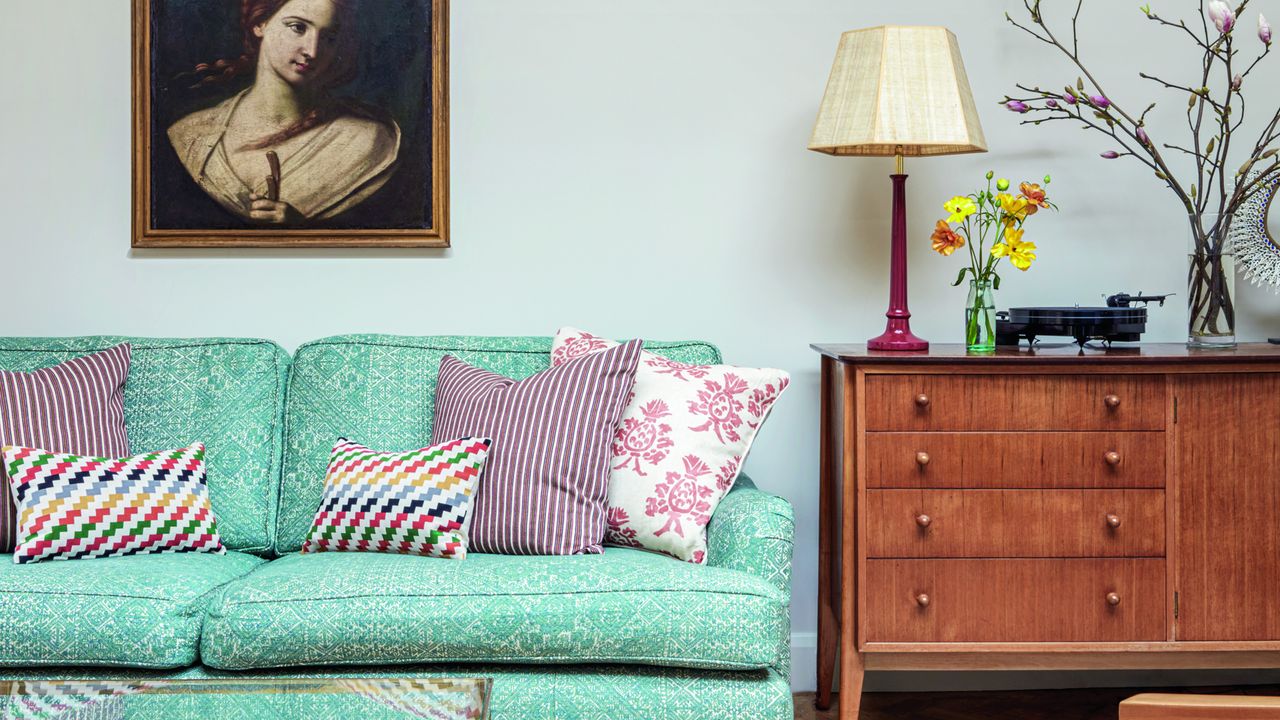 living room with white wall and green sofa